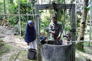Babinsa Serda Bambang Bantu Orang Tua Asuh Timba Air di Sumur