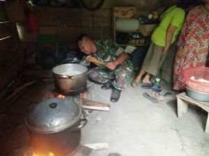 Tak Hanya Fokus di kegiatan Pra TMMD, Serda Alfian juga Bantu Ibu-ibu Memasak di Dapur