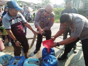Ringankan Beban Masyarakat, Polres Tanjabbar Bagi-bagi Air ke Warga Kuala Tungkal