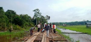 Warga dan Satgas Bergotong Royong Selesaikan Pemasangan Papan Diatas Galar